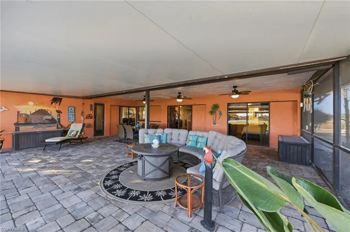 View of patio with an outdoor lounge area and ceiling fan