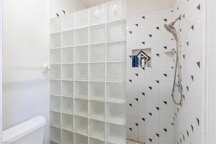 Full bathroom featuring a walk in shower and toilet