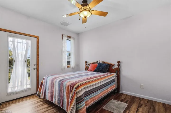 Owner's Bedroom with access to exterior, ceiling fan, and wood-type vinylflooring