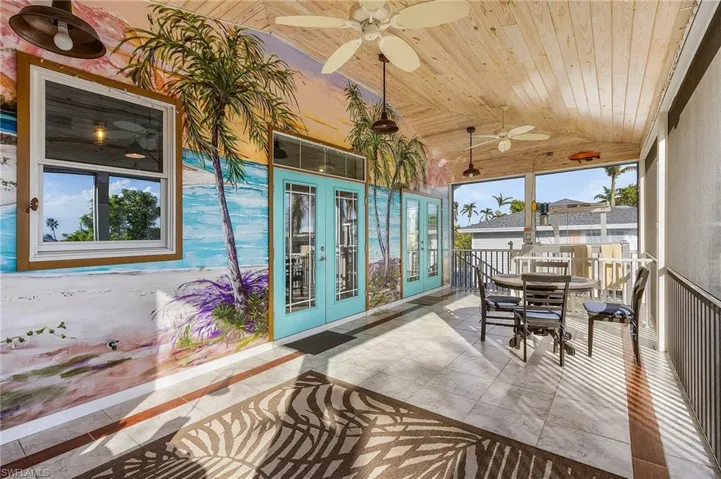 Sunroom featuring french doors, beautiful murals and wood ceiling