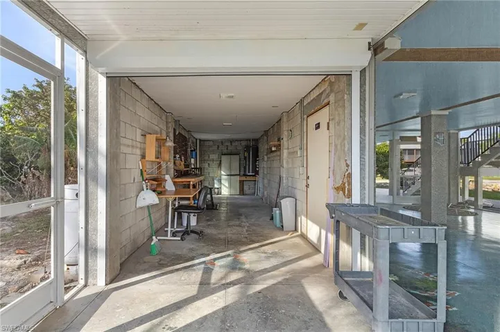 Huge workshop with hurricane shutter that opens to a screened in area.