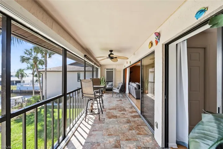 Unfurnished sunroom with ceiling fan
