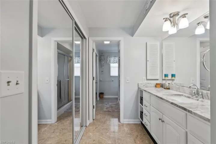 Bathroom with vanity and baseboards