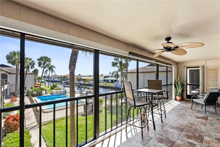 Sunroom featuring a water view and ceiling fan