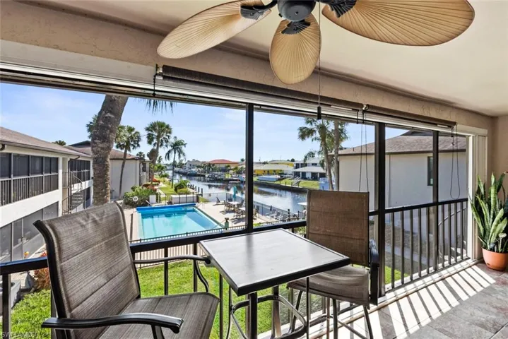 Balcony with a ceiling fan and a water view
