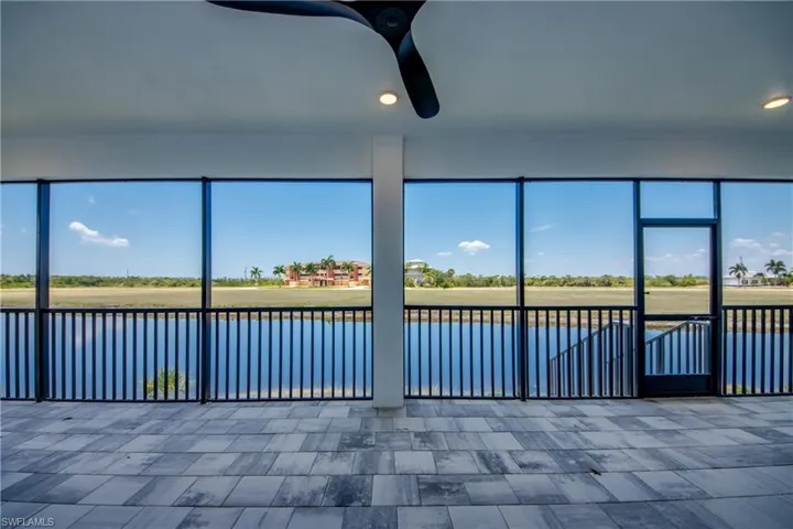Unfurnished sunroom featuring ceiling fan