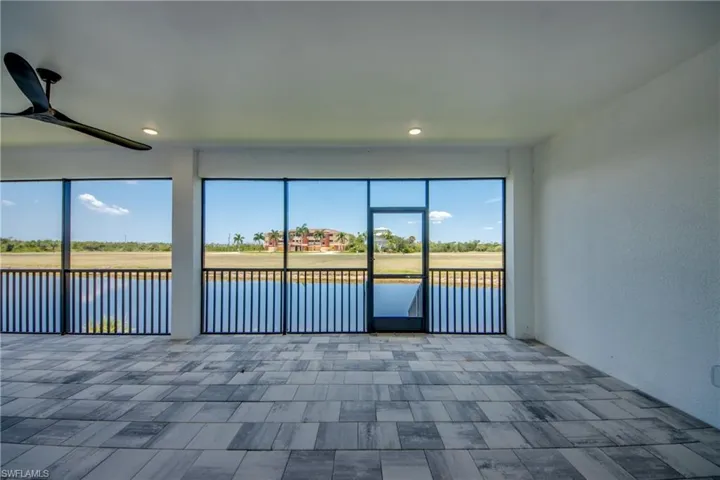 Unfurnished sunroom with ceiling fan