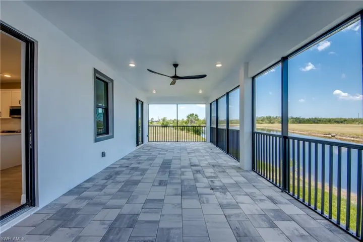 Unfurnished sunroom featuring ceiling fan
