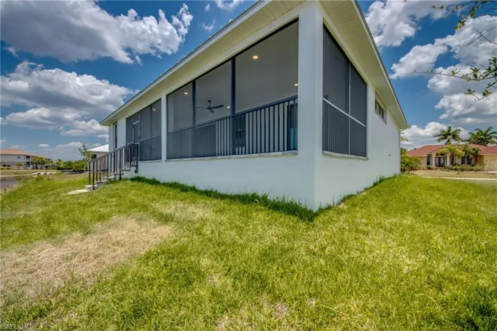 View of side of property with a yard