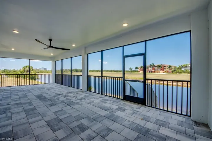 Unfurnished sunroom with ceiling fan
