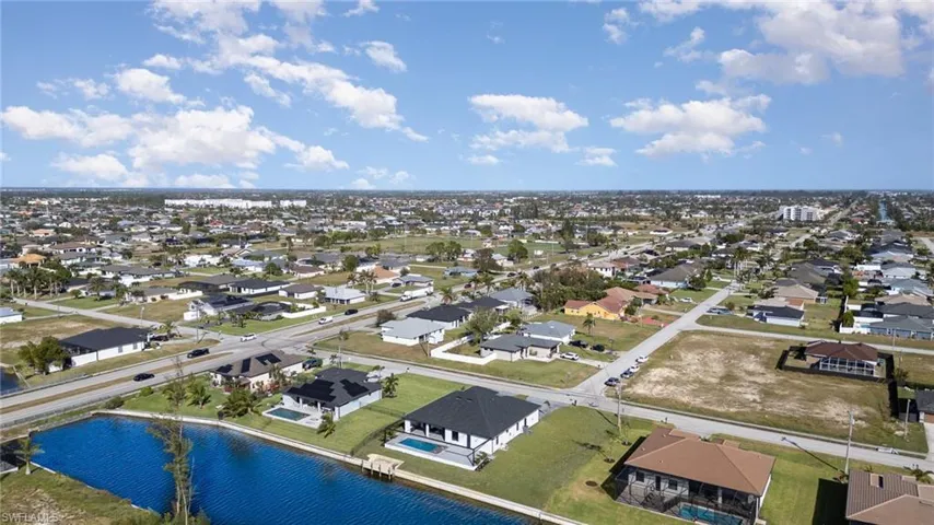 Birds eye view of property with a water view