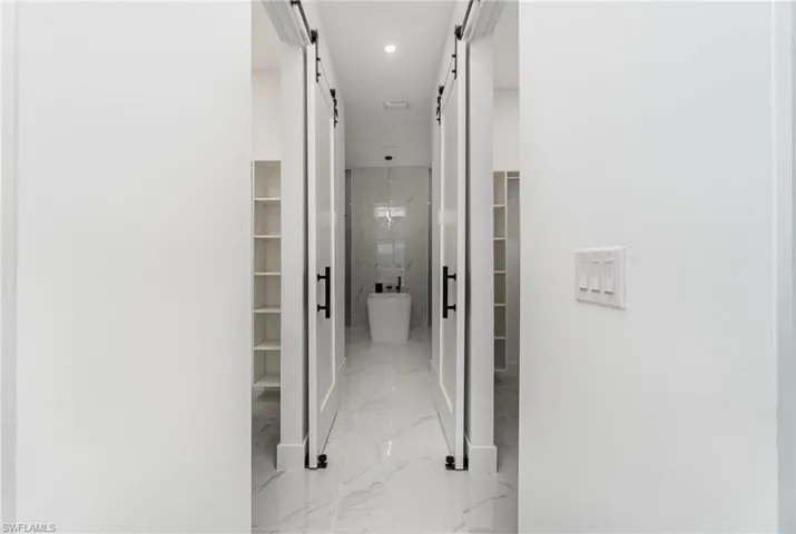 Corridor featuring a barn door