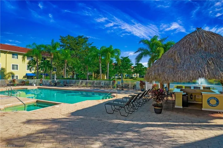 Community pool with a patio area and a community hot tub