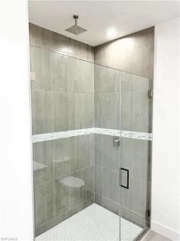 Full bathroom featuring a shower stall and recessed lighting