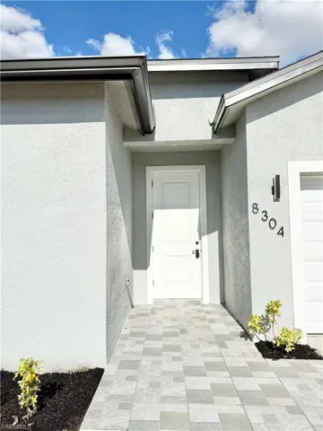 View of exterior entry featuring stucco siding