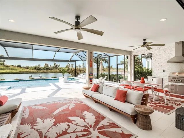 Tiled living room with a water view and ceiling fan