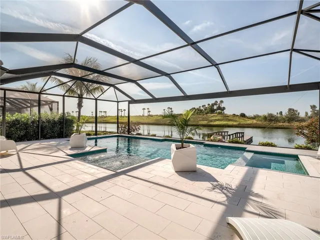 View of swimming pool featuring a water view, a patio area, and a lanai