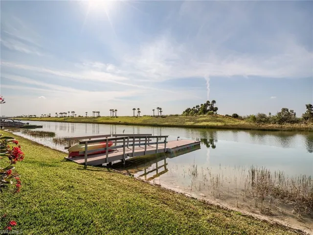 View of dock featuring a yard and a water view