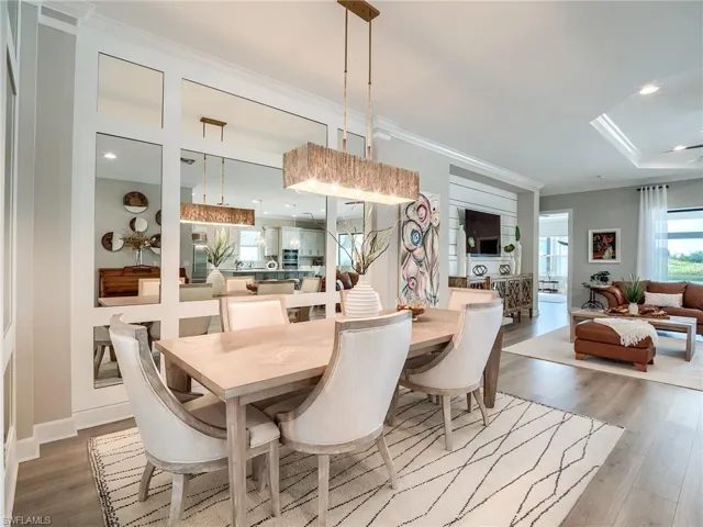 Dining room with ornamental molding and wood-type flooring