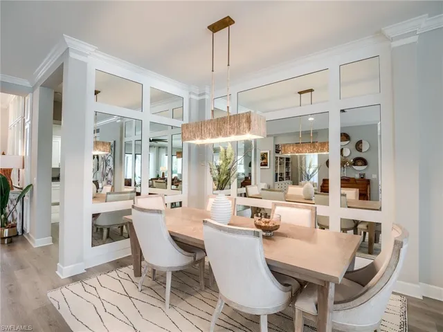 Dining space with ornamental molding and hardwood / wood-style floors