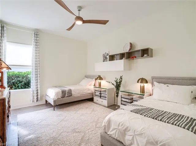 Bedroom with ceiling fan and light hardwood / wood-style flooring