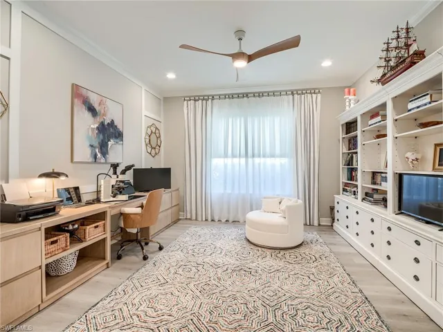 Office featuring crown molding, light wood-type flooring, and ceiling fan