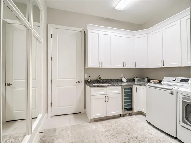 Utility room with custom mirrirs, bev cooler and extra cabinetry