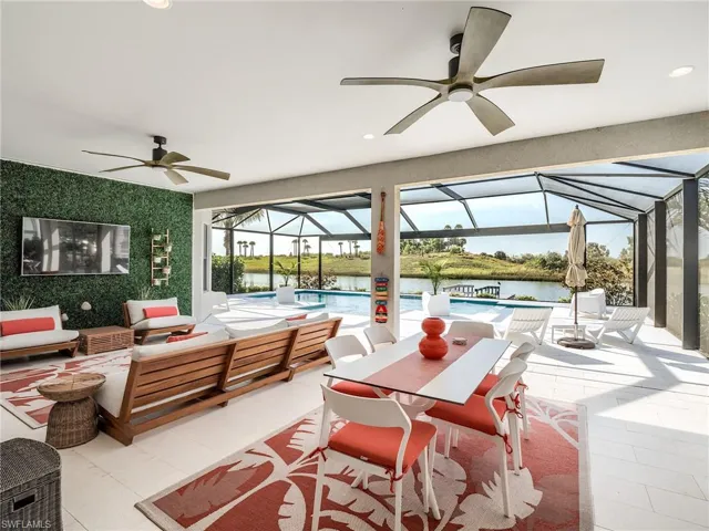 View of patio / terrace with an outdoor hangout area, a water view, glass enclosure, and ceiling fan