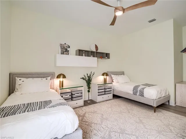 Bedroom featuring light hardwood / wood-style floors and ceiling fan