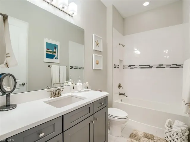 Utility room with custom mirrirs, bev cooler and extra cabinetry
