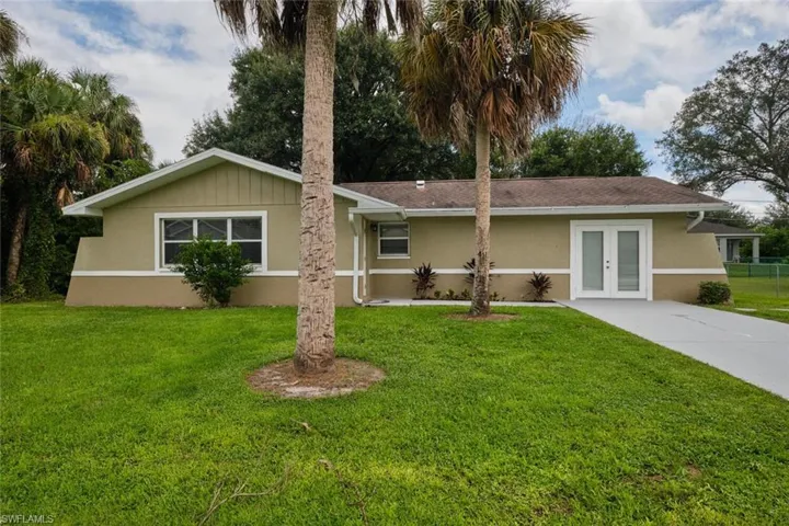 Ranch-style house featuring french doors and a front yard