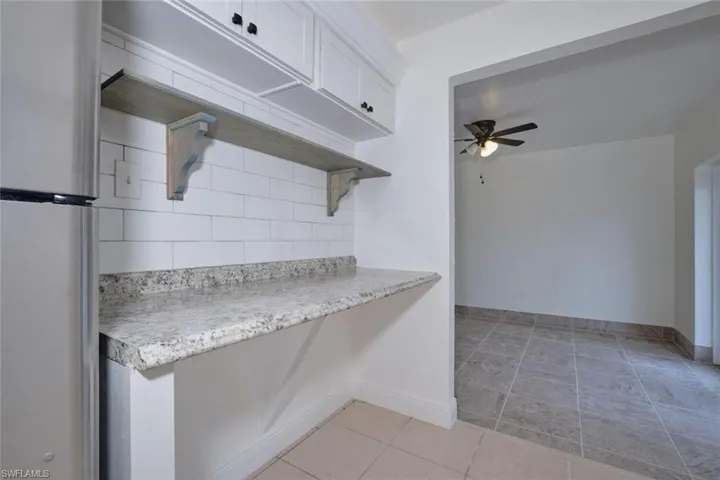 Kitchen with white cabinets, ceiling fan