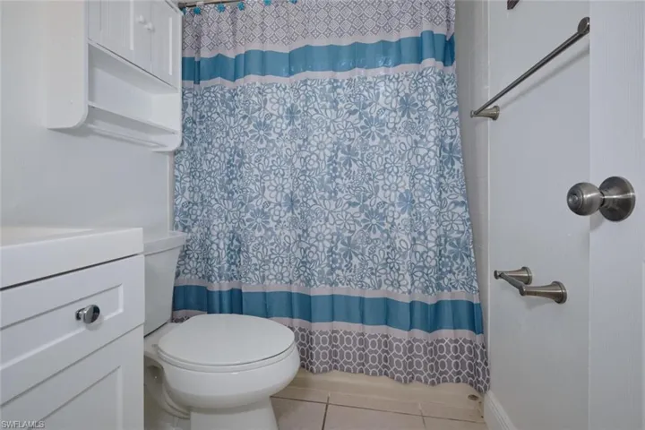 Bathroom with vanity, tile patterned flooring, and toilet