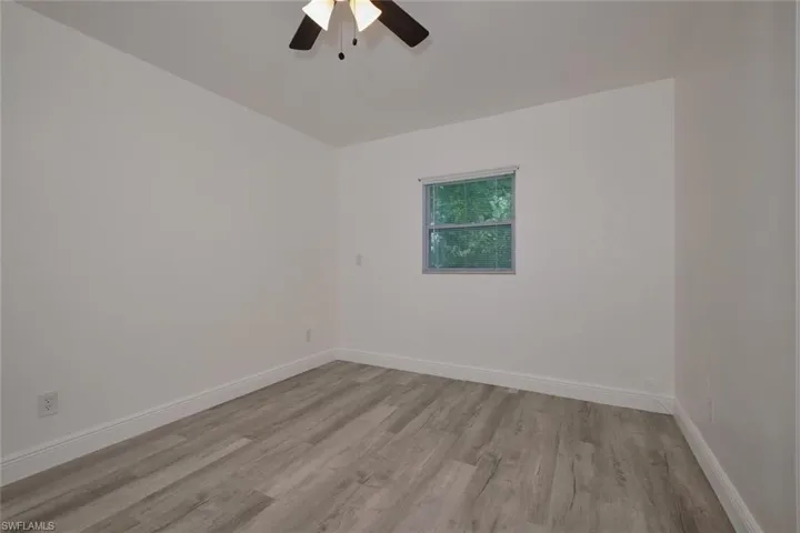 Unfurnished room with light wood-type flooring and ceiling fan