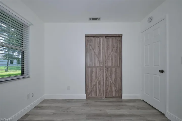 Unfurnished bedroom featuring light wood-type flooring