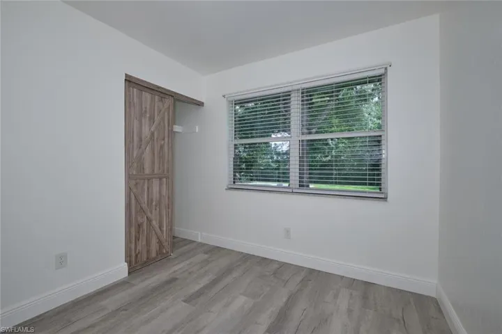 Empty room with light hardwood / wood-style flooring and plenty of natural light