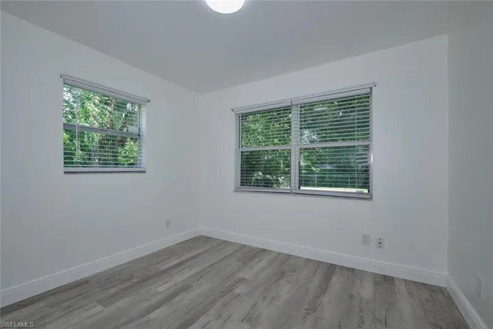 Empty room with light hardwood / wood-style floors