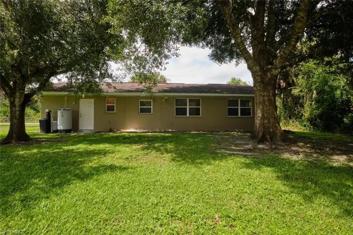 Rear view of property featuring a lawn