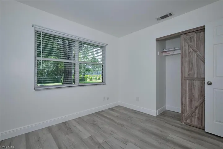 Unfurnished bedroom with light wood-type flooring and a closet