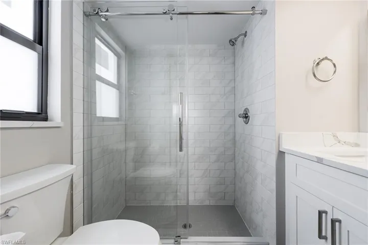 Bathroom featuring a stall shower and vanity