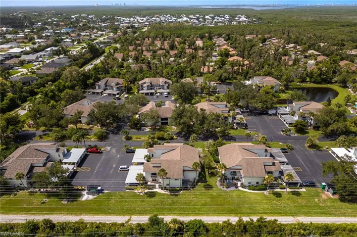 Aerial view of property and surrounding area with nearby suburban area