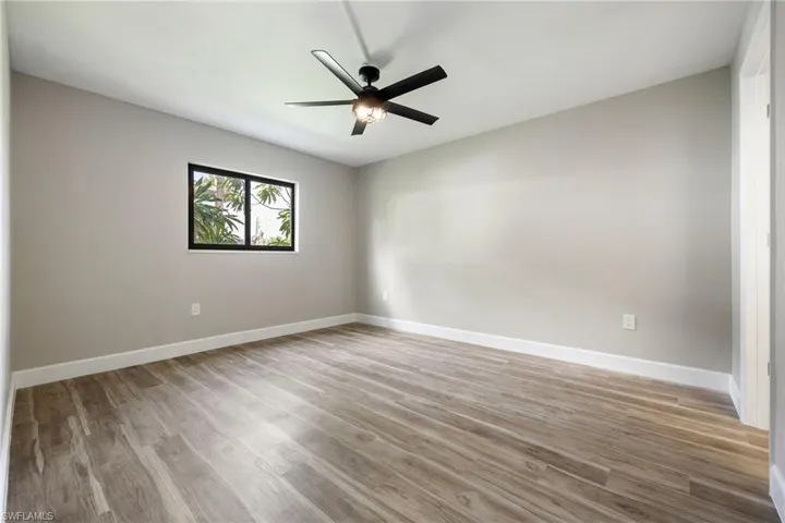 Empty room featuring wood finished floors and ceiling fan