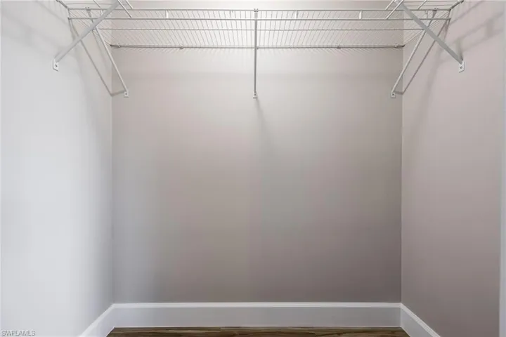 Walk in closet featuring wood finished floors