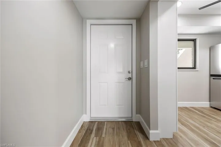 Doorway to outside featuring wood finished floors and baseboards