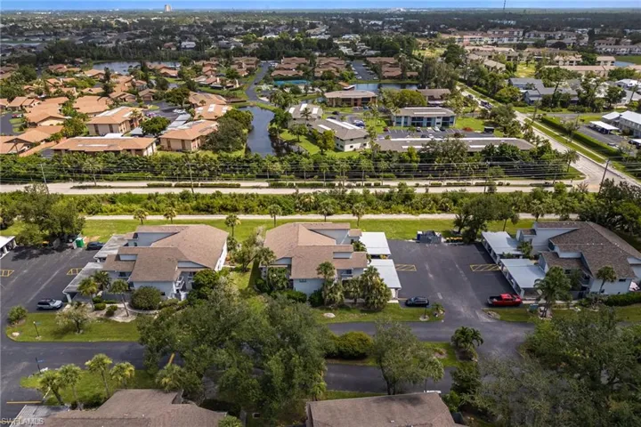 Aerial view of property's location with nearby suburban area and a nearby body of water