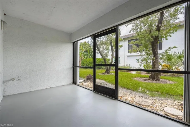 Unfurnished sunroom with lofted ceiling