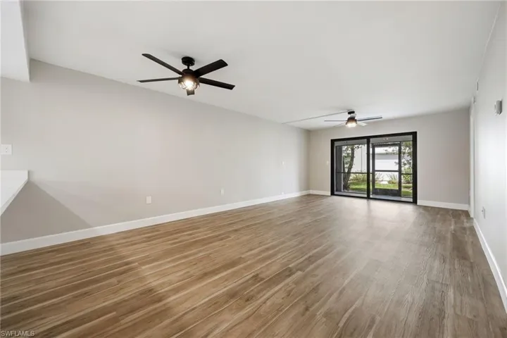 Spare room with wood finished floors and a ceiling fan