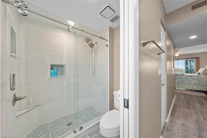 Bathroom with toilet and an enclosed shower