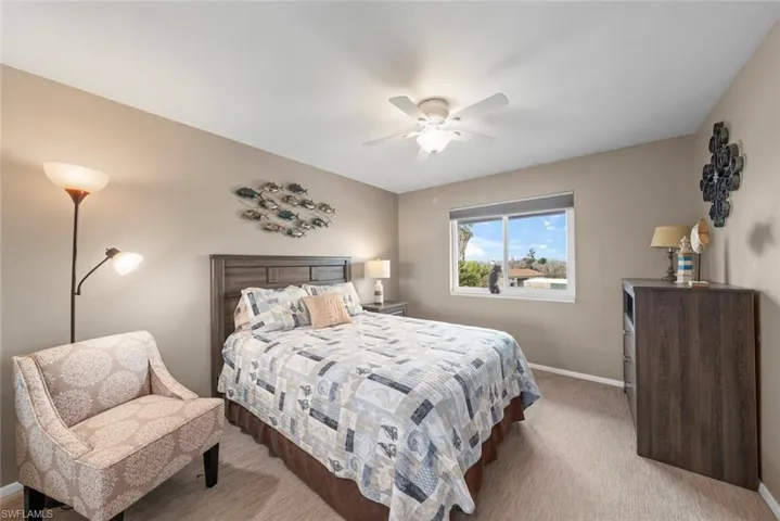 Bedroom with light carpet and ceiling fan