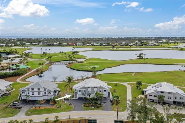 Birds eye view of property with a water view